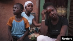 Refugees from the Malian town of Gao, which is now under the control of Islamist forces, pose at a private accommodation in the capital Bamako, September 8, 2012. 