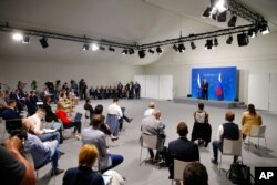 Russia's President Vladimir Putin stands on a podium as he addresses the media during a press conference after the U.S.-Russia summit with U.S. President Joe Biden at Villa La Grange in Geneva, Switzerland, June 16, 2021.