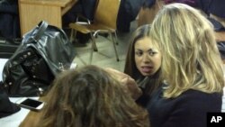 Karima el-Mahroug, center, the Moroccan woman at the center of ex-Prime Minister Silvio Berlusconi's sex-for-hire trial, Milan, Jan. 14, 2013.