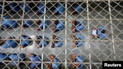 Inmates sit on the floor during an inspection visit in the long-term sentence zone inside Klong Prem high-security prison in Bangkok, Thailand July 12, 2016. 