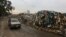 A car passes by a pile of garbage in Karantina, east Beirut, Lebanon, Dec. 17, 2015.