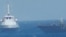 An Iranian vessel steers close to the U.S. Navy coastal patrol craft USS Thunderbolt (R) in the Persian Gulf in a still image from video provided by the U.S. Navy, July 25, 2017.