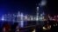 People rest along a waterfront at Hong Kong's Victoria Harbour facing the Hong Kong island side, China
