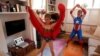 Dressed as superheroes, Jo Proudlove and daughter Eve, 9, follow the daily online &quot;PE with Joe&quot; Joe Wickes&#39; exercise class on &quot;Fancy dress Friday,&quot; at home in London, as the spread of the coronavirus disease (COVID-19) continues.