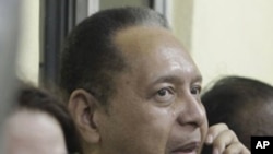 Jean Claude Duvalier and his wife, at Haiti's international airport, 16 Jan 2011