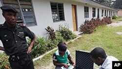 A police officer provides security as Electoral Officials check voter registration material and election equipment at a distribution center in Lagos, Nigeria, 15 Jan. 2011