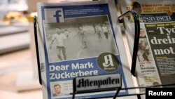 The front page of Norway's Aftenposten is seen at a news stand in Oslo, Norway, Sept. 9, 2016. The newspapers chief editor accused Facebook of abusing its power after it deleted an 1972 iconic image of a nude Vietnamese girl running from a napalm attack.