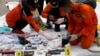 Rescue workers lay out recovered belongings believed to be from the crashed Lion Air flight JT610 at Tanjung Priok port in Jakarta, Indonesia, October 30, 2018. 