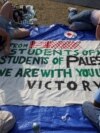 Students at Columbia University paint a response to a message written by Palestinians in Rafah thanking students for their support as they continue to maintain a protest encampment on campus, April 28, 2024. 