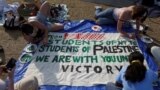 Students at Columbia University paint a response to a message written by Palestinians in Rafah thanking students for their support as they continue to maintain a protest encampment on campus, April 28, 2024. 