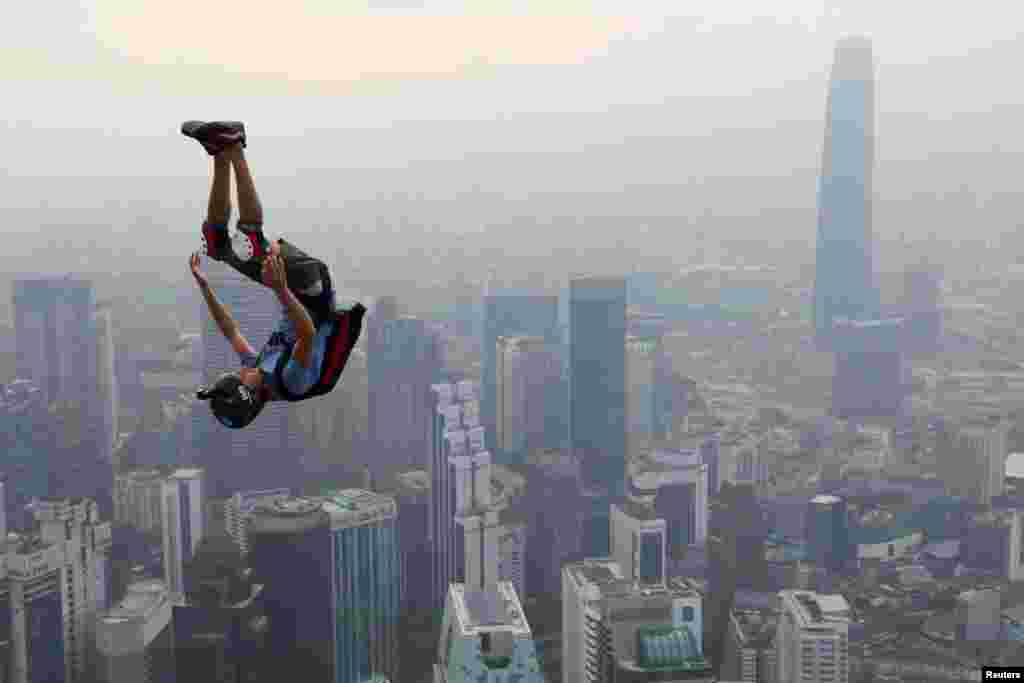 A BASE jumper leaps from Kuala Lumpur Tower on a hazy day during International Jump Malaysia 2019 in Kuala Lumpur, Malaysia.