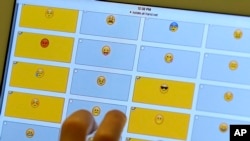 FILE - In this Feb. 15, 2016 photo, a student demonstrates how emojis are used during a research session on the Kansas State University campus in Olathe, Kan.