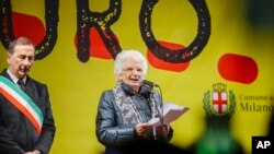 Liliana Segre, an 89-year-old Auschwitz survivor and senator-for-life, right, flanked by Milan's Mayor Giuseppe Sala speaks at an anti-racism demonstration in Milan's Victor Emmanuel II arcade in northern Italy.