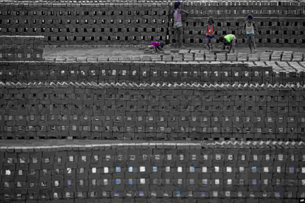 Children work in a brick kiln on the outskirts of Gauhati, northeastern Assam state, India.