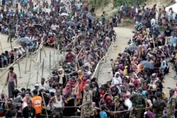 FILE - Rohingya refugees queue for aid at Cox's Bazar, Bangladesh, Sept. 26, 2017.