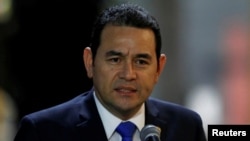 FILE - Guatemala's President Jimmy Morales speaks to the media after his arrival at Mariscal Sucre Airport in Quito, Ecuador, May 23, 2017. 