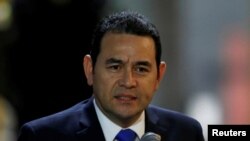 FILE - Guatemala's President Jimmy Morales speaks to the media after his arrival at Mariscal Sucre Airport in Quito, Ecuador, May 23, 2017, ahead of Ecuadorean president inauguration. 