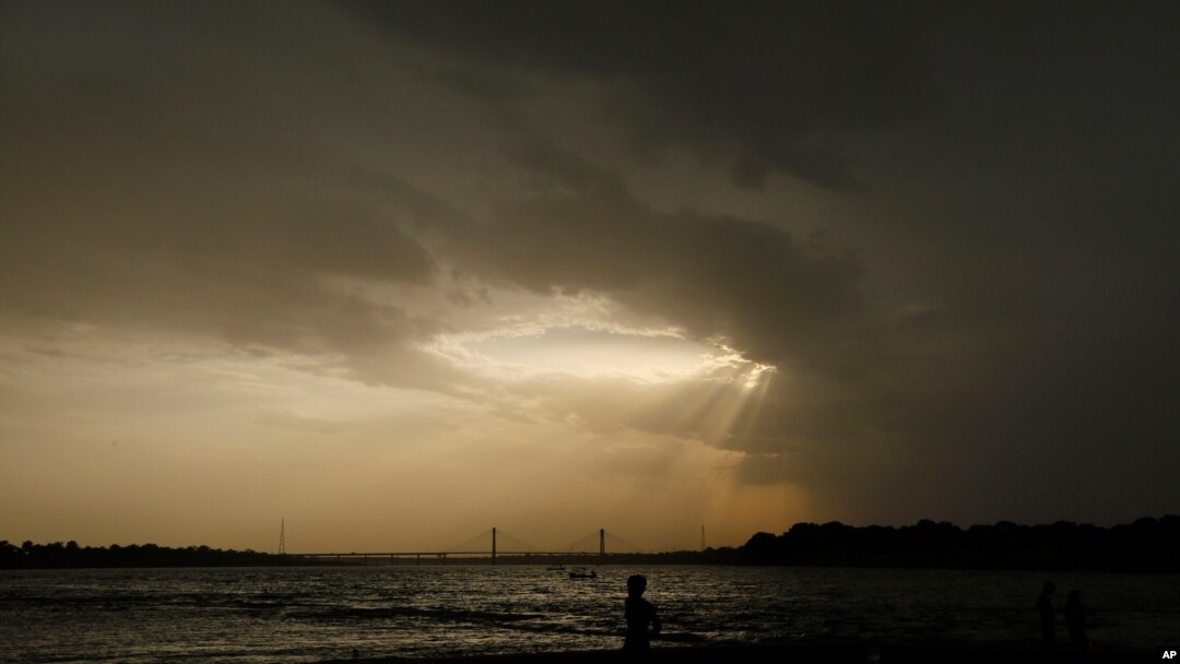 In this Wednesday, May 27, 2020 file photo, a boy stands on the shore of the Ganges River during a hot summer day in Prayagraj, India.