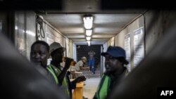 Mineworkers gather inside the entrance to the Gold One Modder East operation mineshaft in Springs, on October 24, 2023.