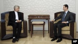 In this photo released by the Syrian official news agency SANA, Iran's Supreme National Security Council, Saeed Jalili, meets with Syrian President Bashar Assad in Damascus, August 7, 2012. 