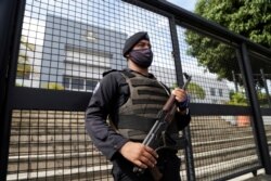 A Nicaraguan police officer keeps watch outside the Supreme Electoral Council as political parties register their presidential candidates for the November 7 general election. (Maynor Valenzuela/Reuters)