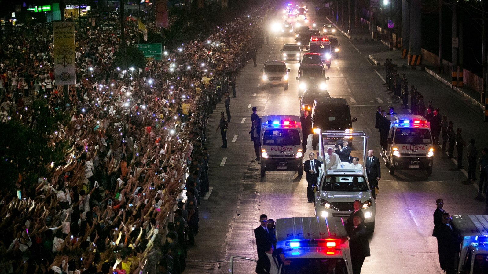 A huge crowd of Filipino faithful gather in excitement along Roxas Boulevard in Manila, Philippines, as they welcome the motorcade of Pope Francis, who arrived on Thursday, Jan. 15, 2015 to begin his Apostolic visit. 