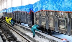 This undated picture released from North Korea's official Korean Central News Agency on March 4, 2020 shows workers disinfecting freight trains to prevent the spread of the COVID-19 coronavirus in Sinuiju, North Pyongan Province.