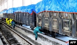 This undated picture released from North Korea's official Korean Central News Agency on March 4, 2020 shows workers disinfecting freight trains to prevent the spread of the COVID-19 coronavirus in Sinuiju, North Pyongan Province.