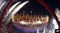FILE - Fireworks ignite over Olympic Stadium during opening ceremonies of the 2012 Summer Olympics in London, July 28, 2012.