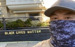James "Jaime" Juanillo stands in front of the Black Lives Matter wall art that prompted a woman to question whether he was defacing private property at his San Francisco home. (Courtesy James Juanillo)