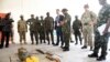 Commander Major General Adekunle Shodunke (C-R) points to IEDs recovered from Boko Haram Islamists as British Minister of State for the Armed Forces Mark Lancaster looks on in Makurdi, Benue State, north-central Nigeria, on October 4, 2017.