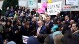 Senate Minority Leader Chuck Schumer speaks as U.S. Representative Maxine Waters stands next to him, while demonstrators rally outside the U.S. Treasury Department in Washington on Feb. 4, 2025. 