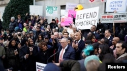 Senate Minority Leader Chuck Schumer speaks as U.S. Representative Maxine Waters stands next to him, while demonstrators rally outside the U.S. Treasury Department in Washington on Feb. 4, 2025. 