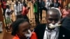 Employees of the Daily Monitor newspaper with their mouths taped shut, sing slogans during a protest against the closure of their premises by the Uganda government, outside their offices in the capital Kampala, Uganda, May 20, 2013.