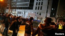 Security personnel form a cordon as the convoy carrying the World Health Organization team tasked with investigating the origins of the COVID-19 pandemic leaves the Wuhan Center for Disease Control and Prevention, Feb. 1, 2021.