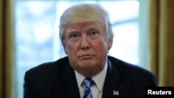 U.S. President Donald Trump talks to journalists at the Oval Office of the White House after the American Health Care Act was pulled before a vote in Washington, March 24, 2017.