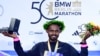 Ethiopia's Milkesa Mengesha celebrates on the podium after winning the 50th edition of the Berlin Marathon in Berlin, Sept. 29, 2024.