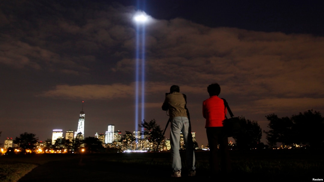 Annual Tribute in Light tested in New York's Lower Manhattan as a man takes a picture at Liberty State Park in Jersey City, New Jersey, September 9, 2013.
