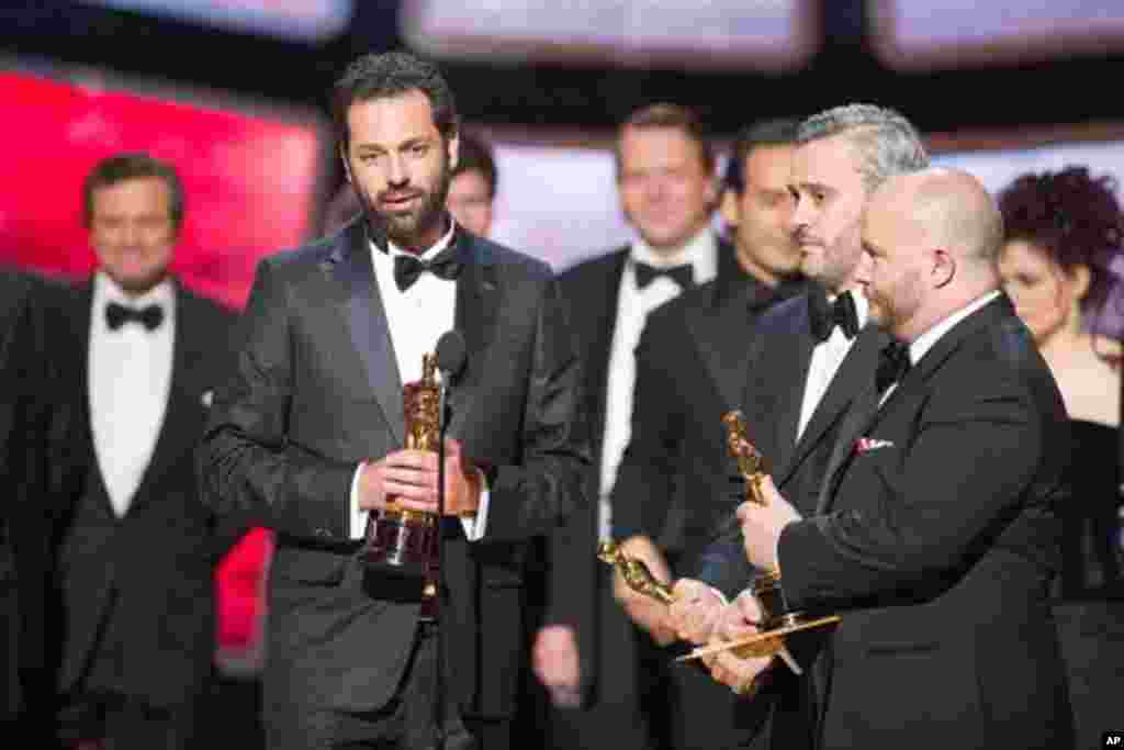 Emile Sherman, Iain Canning and Gareth Unwin accept the Oscar® for Best Motion Picture of the Year for “The King's Speech,” produced by Iain Canning, Emile Sherman and Gareth Unwin