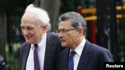 Former Goldman Sachs Group Inc. board member Rajat Gupta, right, and lawyer Gary Naftalis arrive at Manhattan Federal Court in New York, June 14, 2012.