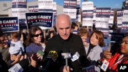 FILE - Sen. Bob Casey of Pennsylvania stops to speak to members of the media before voting, Nov. 5, 2024, in Scranton, Pa. 