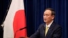 FILE - Japanese Prime Minister Yoshihide Suga speaks at a news conference in Tokyo, Dec. 4, 2020. 