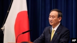 Japanese Prime Minister Yoshihide Suga speaks during a news conference in Tokyo on Friday, Dec. 4, 2020. Suga announced a 2 trillion green fund to promote innovation and technology to achieve his pledge to achieve a carbon free society by 2050. (AP…