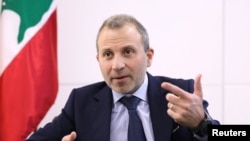 FILE - Gebran Bassil, a Lebanese politician and head of the Free Patriotic movement, talks during an interview with Reuters in Sin-el-fil, July 7, 2020.