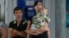 Local residents wait for a bus as they try flee fighting in the eastern Ukrainian city of Slovyansk June 10, 2014.