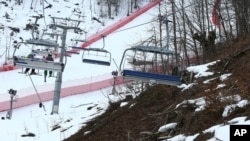 Snow and brown patches are seen near the alpine course at the Sochi 2014 Winter Olympics, Krasnaya Polyana, Russia, Feb. 11, 2014.