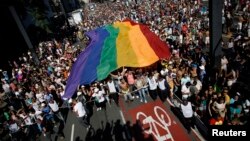 Activists carry a rainbow flag during a gay pride parade in Sao Paulo, Brazil, May 4, 2014.