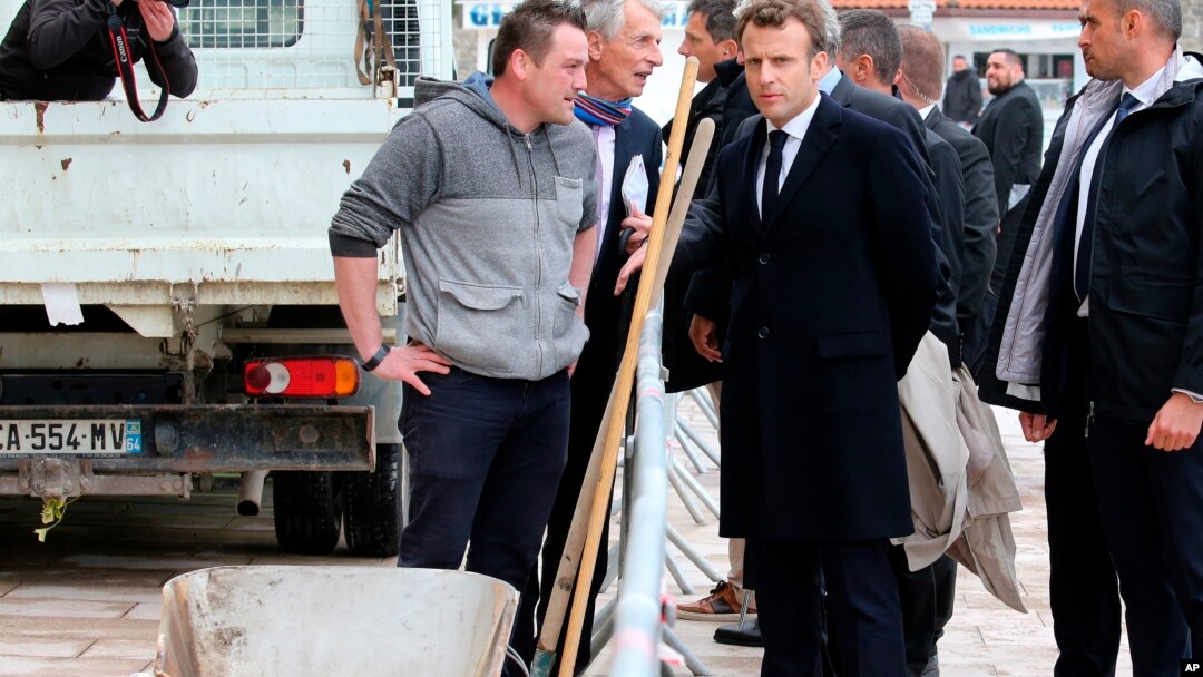 France's President Emmanuel Macron talks to a worker during a visit to Biarritz, southwestern France, May 17, 2019. 