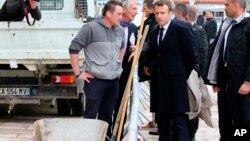 France's President Emmanuel Macron talks to a worker during a visit to Biarritz, southwestern France, May 17, 2019. 