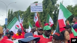 Labour unionists march in the streets of Abuja, Nigeria, Wednesday, Aug. 2, 2023, to protest the soaring cost of living under the West African nation's new president